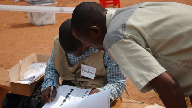 Checking for the names of a voter by the presiding official